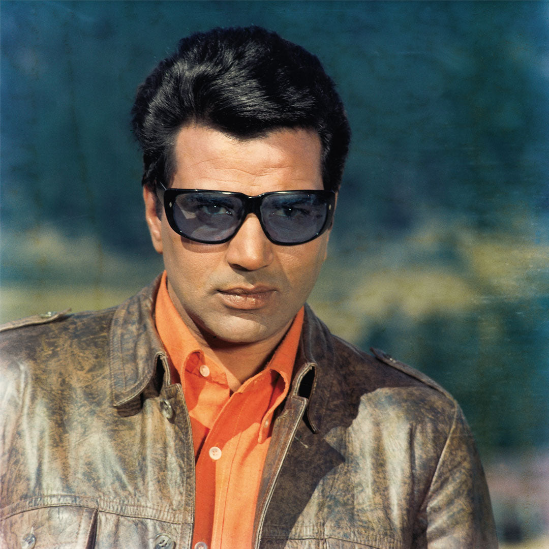 Dharmendra Portrait in a Orange Shirt and Brown Jacket with Gogles- still from the movie “Lalkar” Personal Bollywood Photography of renowned cinematographer, Shri Prem Sagar.